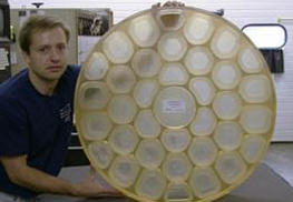 Man Holding Optical Components, Prototype Machine Shop, Boston, MA
